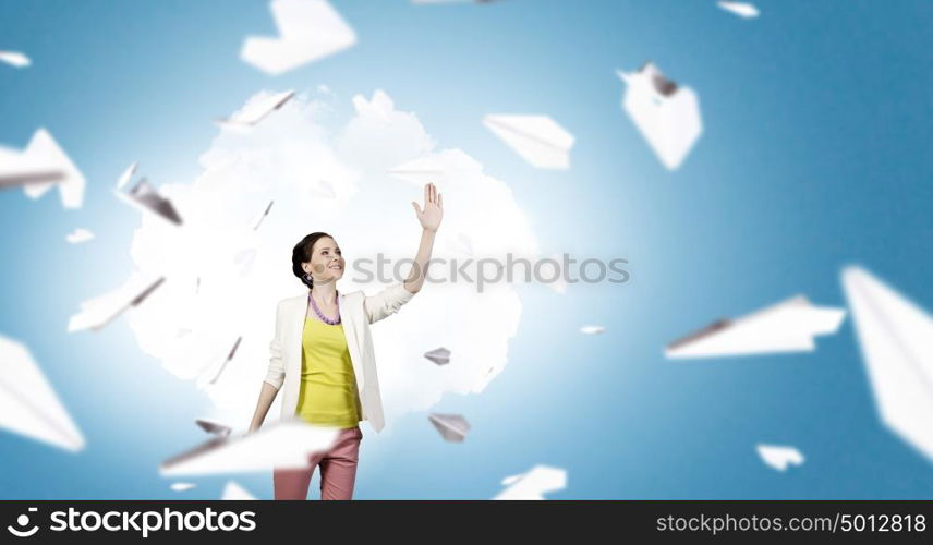 Free and careless. Young woman in casual and many paper planes flying around