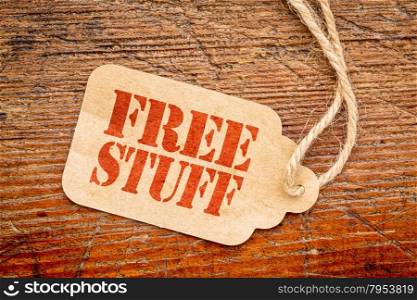 free stuff sign - a paper price tag against rustic red painted barn wood