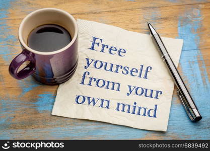 Free yourself from your own mind - inspirational handwriting on a napkin with a cup of espresso coffee