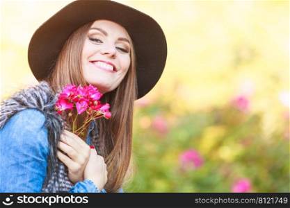 Freedom and leisure. Gorgeous adorable woman holding pink flowers. Romantic portrait of beautiful young lady.. Beauty woman with flowers