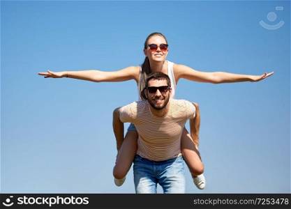 freedom and people concept - happy couple having fun in summer. happy couple having fun in summer