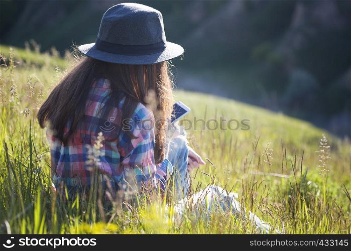 freedom - beautiful teen girl on the nature with smartphone