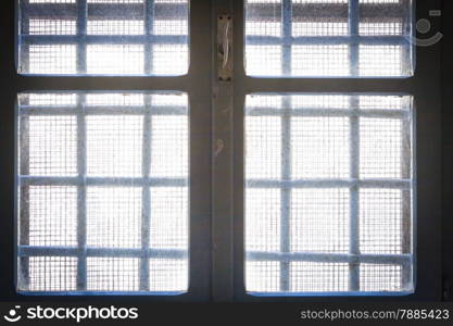 Freedom beyond the window. Bars in old prison
