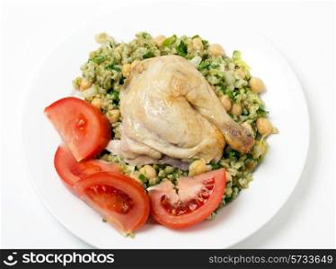 Freekeh salad with chickpeas, onion, parsley, celery, and a lemon juice and olive oil dressing, and a chicken leg with tomato