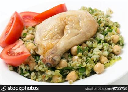 Freekeh salad with chickpeas, onion, parsley, celery, and a lemon juice and olive oil dressing, and a chicken leg with tomato