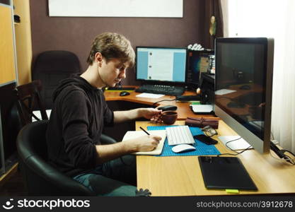 Freelance developer and designer working at home, man using desktop computer.