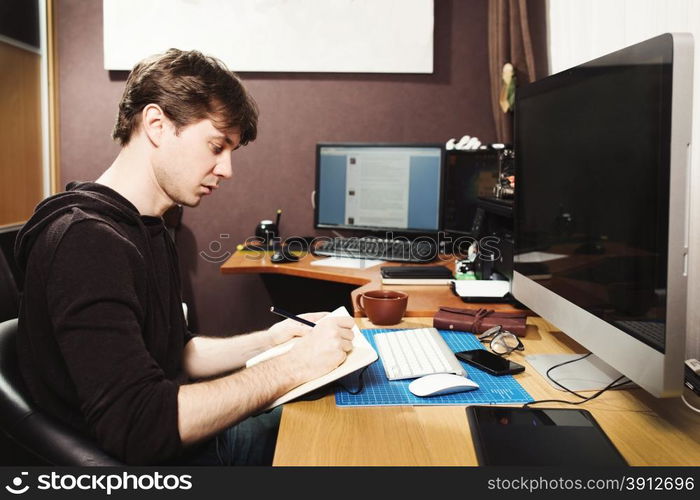 Freelance developer and designer working at home, man using desktop computer.