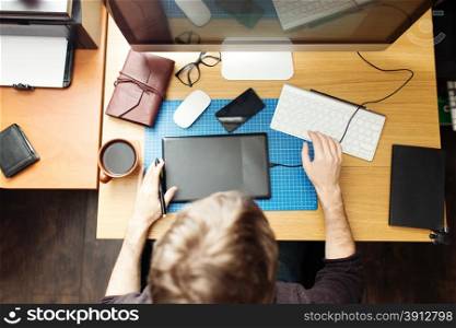 Freelance developer and designer working at home, man using desktop computer.