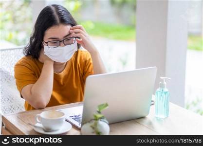 freelance people business female wearing protective mask casual and writing message on smartphone working with laptop computer ,working from home,Concept of Prevention of the spread of COVID-19 virus