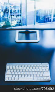 Freelancer's workplace: Keyboard in the foreground, blurry screen in the background