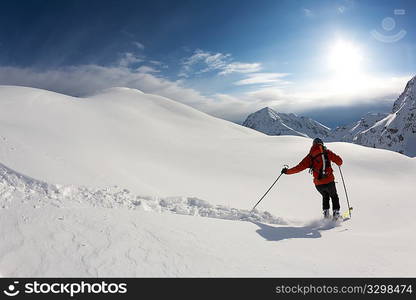 Freerider skier moving down in snow powder; italian alps.