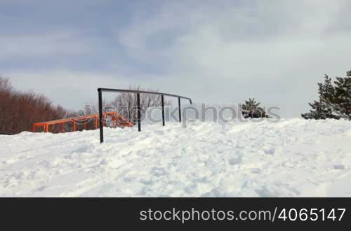 freestyle skier grinding down a rail