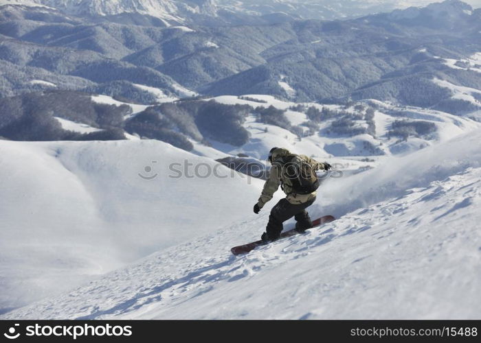 freestyle snowboarder jump and ride free style at sunny winter day on mountain