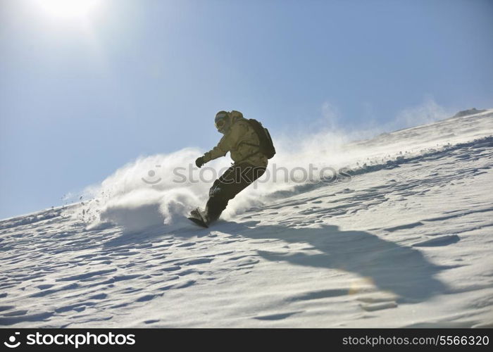 freestyle snowboarder jump and ride free style at sunny winter day on mountain