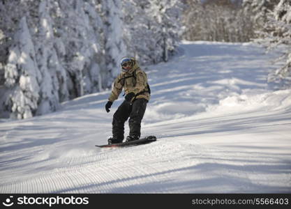 freestyle snowboarder jump and ride free style at sunny winter day on mountain