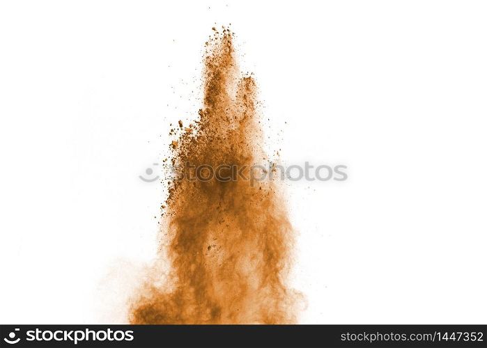 Freeze motion of brown color powder exploding on white background.