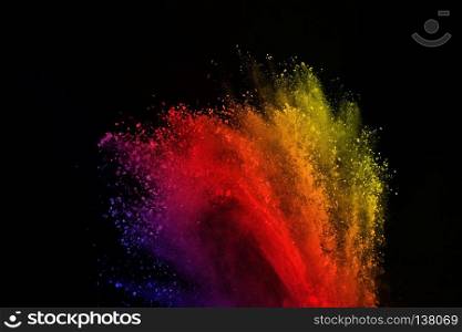 Freeze motion of colored powder explosion isolated on black background. Abstract of colorful dust splatted.