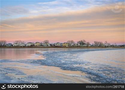 freezing lake after sunset with houses at waterfront - Boyd Lake in northern Colorado