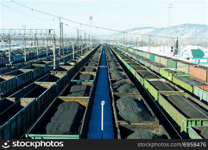 Freight trains with coal at marshalling yard. Cargo wagons at the railway station.. Freight trains with coal at marshalling yard