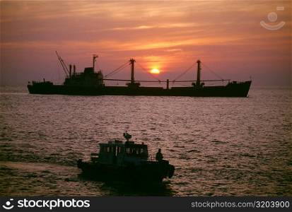 Freighter at sunset in the South China Sea, Vietnam