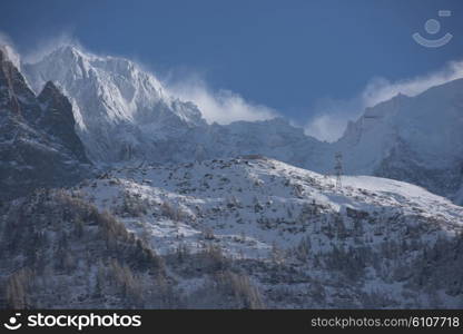 French alps mountain peaks covered with fresh snow. Winter landscape nature scene on beautiful sunny winter day.