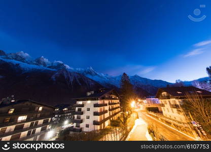 French alps mountain peaks covered with fresh snow. Winter landscape nature scene on night.