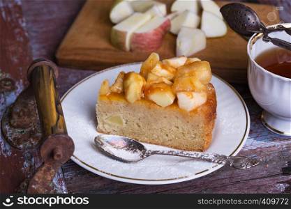 French apple pie on a plate on a vintage background