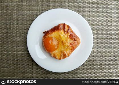 French baked pastry beautiful sweet glazed apricot danish on white plate