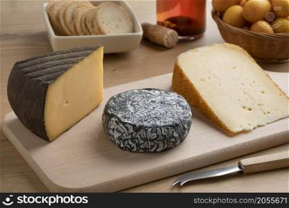 French cheese platter with three different types of cheese as dessert