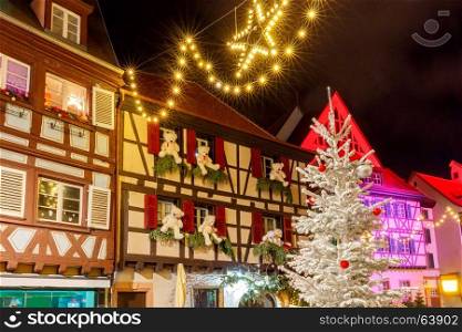 French city Colmar on Christmas Eve.. Traditional old half-timbered houses in the historic city of Colmar. Decorated and lighted during the Christmas season. Alsace. France.