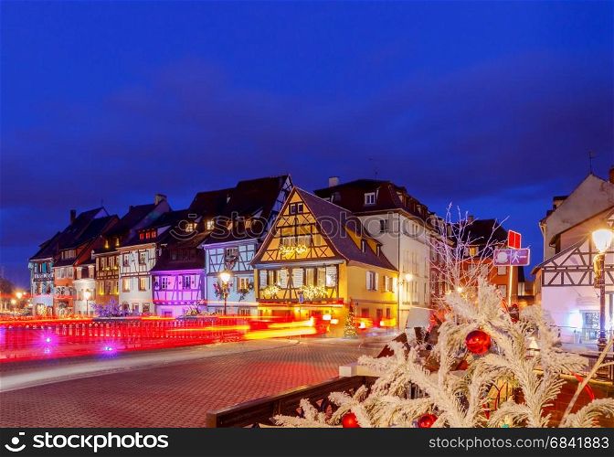 French city Colmar on Christmas Eve.. Traditional old half-timbered houses in the historic city of Colmar. Decorated and lighted during the Christmas season. Alsace. France.