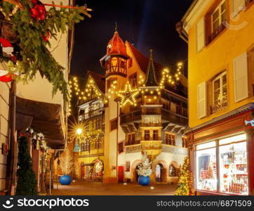 French city Colmar on Christmas Eve.. Traditional old half-timbered houses in the historic city of Colmar. Decorated and lighted during the Christmas season. Alsace. France.