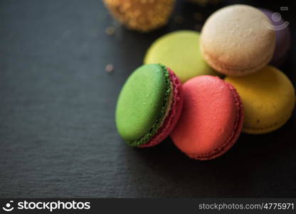 French colorful macarons. French colorful macarons on black background