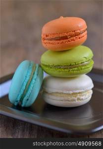 french colorful macarons on wooden table