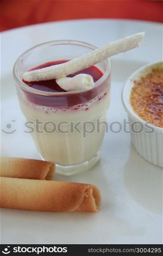 French dessert: blancmange with berry sauce and meringue