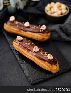 french eclairs with chocolate and hazelnuts