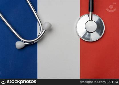 French flag and stethoscope. The concept of medicine. Stethoscope on the flag in the background.. French flag and stethoscope. The concept of medicine.