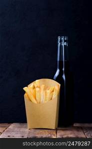 French fries and a drink on wooden table