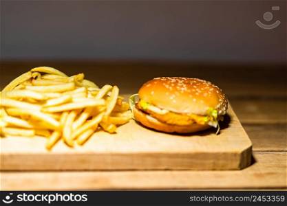 French fries and chicken burger on a wooden table. Food, junk food and fast food concept