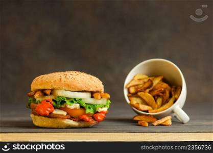 French fries and juicy meat burger with beef, cheese, tomatoes ,lettuce, onion. 