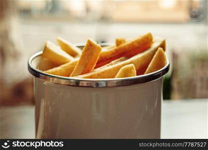 French fries in basket served in cafe angle from above view.. French fries in basket served in cafe from above view.