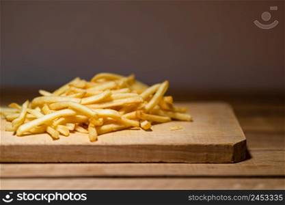 French fries on a wooden table. Food, junk food and fast food concept