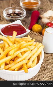 French Fries Potato with Ketchup on Rustic Wooden Background. French Fries Potato with Ketchup