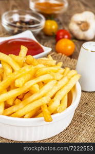 French Fries Potato with Ketchup on Rustic Wooden Background. French Fries Potato with Ketchup