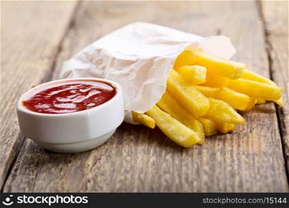 french fries with ketchup on wooden table