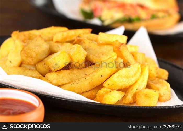 French fries with ketchup (Selective Focus, Focus one third into the fries)