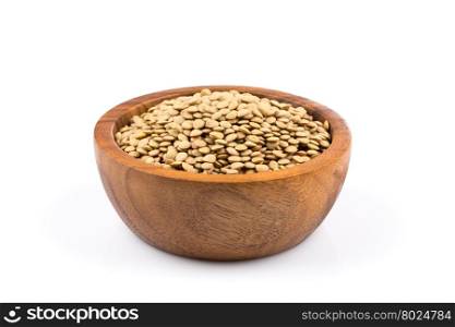 French green lentils (lentilles du Puy) in a wooden bowl on a white background