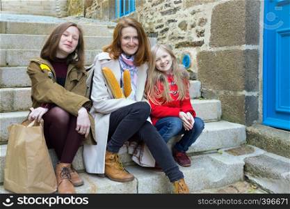 French happy smiling mother with baguettes and daughters