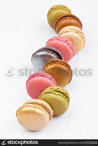 French luxury colorful macarons dessert cakes on white background with sugar on top