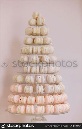 French macaroons. Candy bar. Wedding feast. Wedding sweets. beautiful macaron cake patisserie multi tier stand full of pastel macarons. pyramid tower.. French macaroons. Candy bar. Wedding feast. Wedding sweets. beautiful macaron cake patisserie multi tier stand full of pastel macarons. pyramid tower